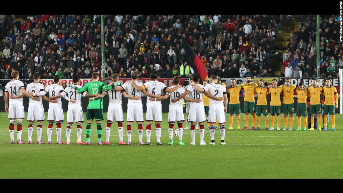 Members of the German and Australian national soccer teams observe a moment of silence before a friendly match in Kaiserslautern, Germany, on March 25.