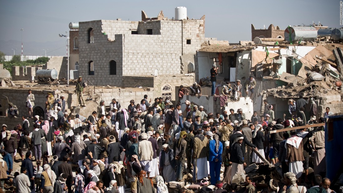People search for survivors under the rubble of houses destroyed by airstrikes near the Sanaa Airport on March 26. 