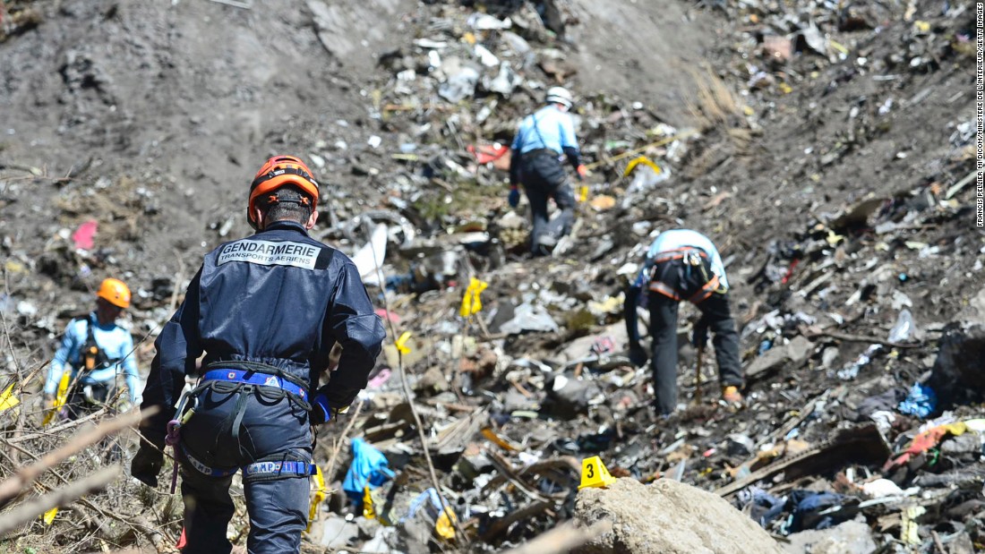Rescue workers continue to search the site of the crash on March 26.