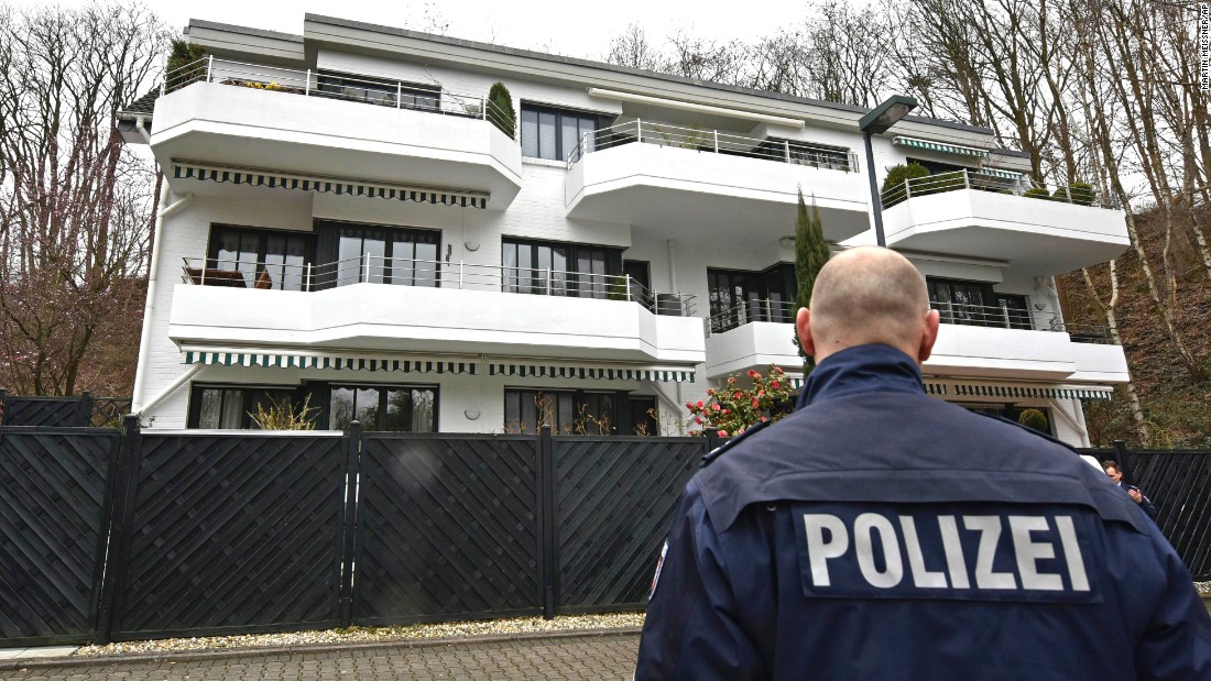 A police officer stands guard March 26 at an apartment building where Lubitz was thought to have lived in Dusseldorf.