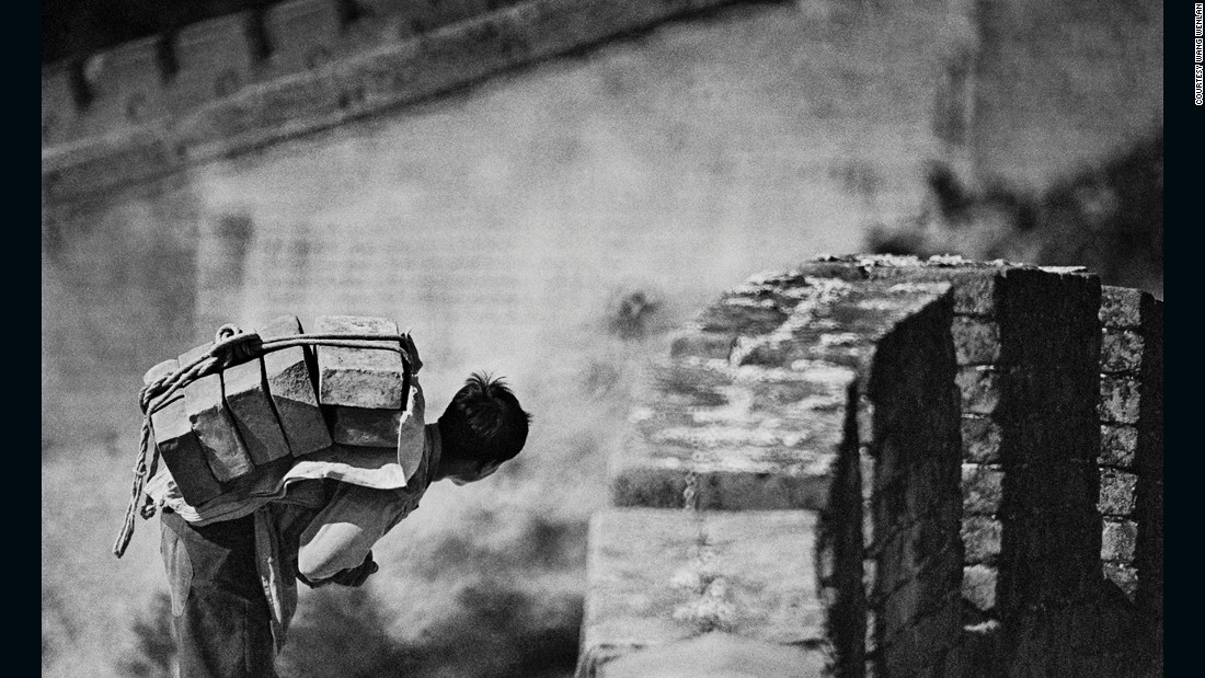 A man carries a load of stones on his back on the Great Wall in 1984. China restored the Great Wall at Badaling in 1984, making it more accessible. It&#39;s one of the most popular tourist sites in Beijing.