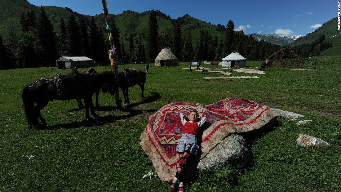 A boy from a nomadic family leans on a rug in 2010 near Ili, Xinjiang.