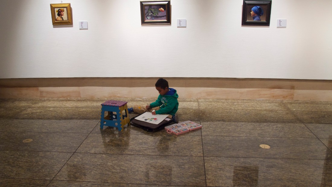 A boy draws in the National Art Museum of China, Beijing 2012. 