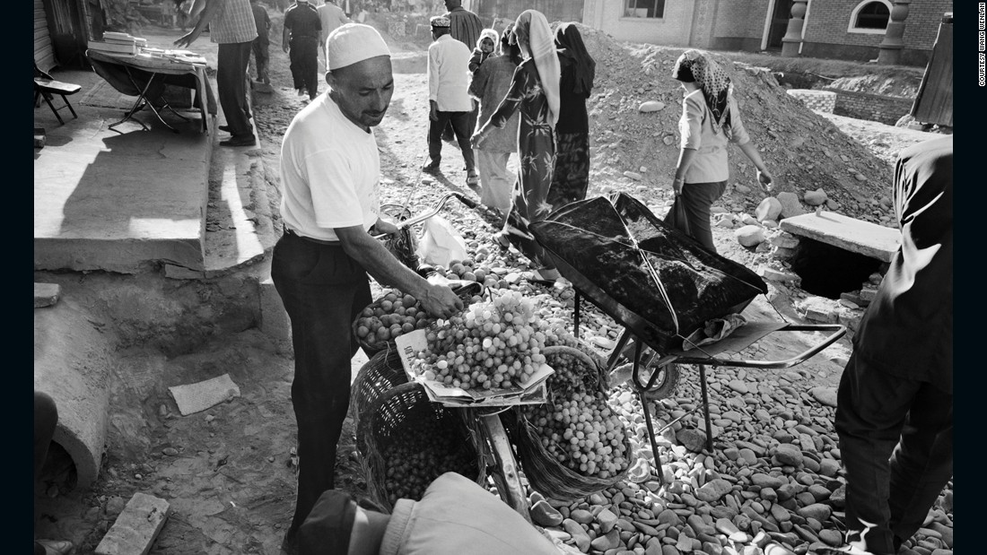 A man sells grapes from his bicycle in Kashgar, Xinjiang province in 2004. Wang Wenlan has traveled across the nation to document life in different regions such as Xinjiang, which is home to the mainly Muslim Uyghurs. 