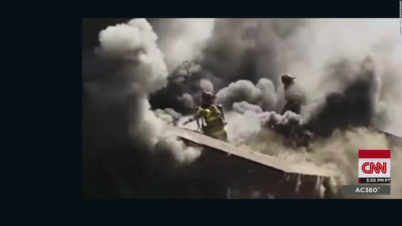 Firefighter Falls Through Burning Roof   CNN Video