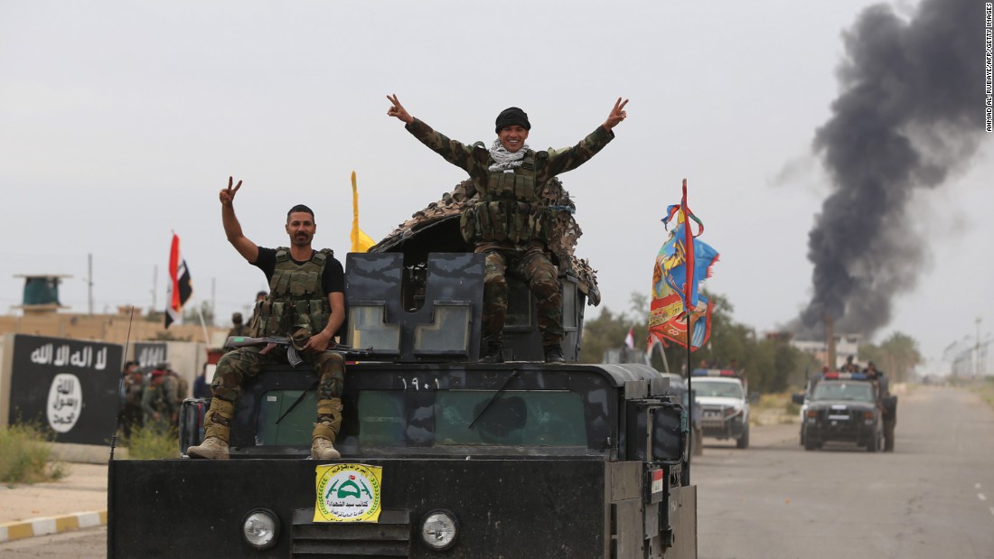 On April 1, Shiite militiamen celebrate the retaking of Tikrit, which had been under ISIS control since June. The push into Tikrit came days after U.S.-led airstrikes targeted ISIS bases around the city.