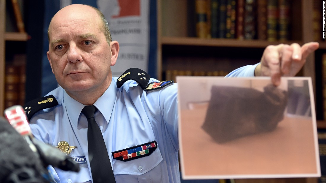 French Gen. David Galtier holds up a picture of the second black box from Germanwings 9525 during a news conference in Marseille, France, on Thursday, April 2. The flight data recorder shows that co-pilot Andreas Lubitz purposely used the controls to speed up the plane&#39;s descent, investigators said. 