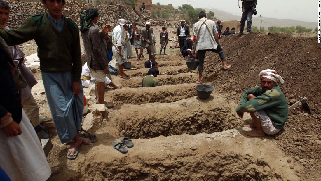 Yemenis dig graves on Saturday, April 4, to bury the victims of a reported airstrike by the Saudi-led coalition in the village of Bani Matar, Yemen.