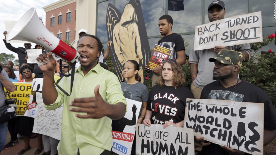 People protest Scott&#39;s shooting as they rally outside North Charleston&#39;s City Hall on April 8.