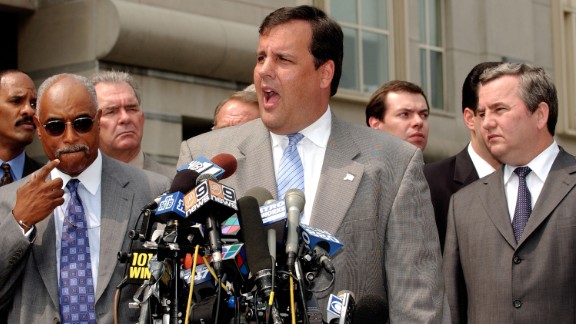 Christie speaks to the media about an FBI sting with Russian Gen. Sergei Fomenko, right, of the Federal Security Service and FBI Agent Louie Allen on August 13, 2003, in Newark, New Jersey.