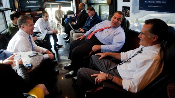 Christie and Republican presidential candidate Mitt Romney speak with Romney adviser Bob White on board the Romney campaign bus in Mount Vernon, Ohio, on October 10, 2012.