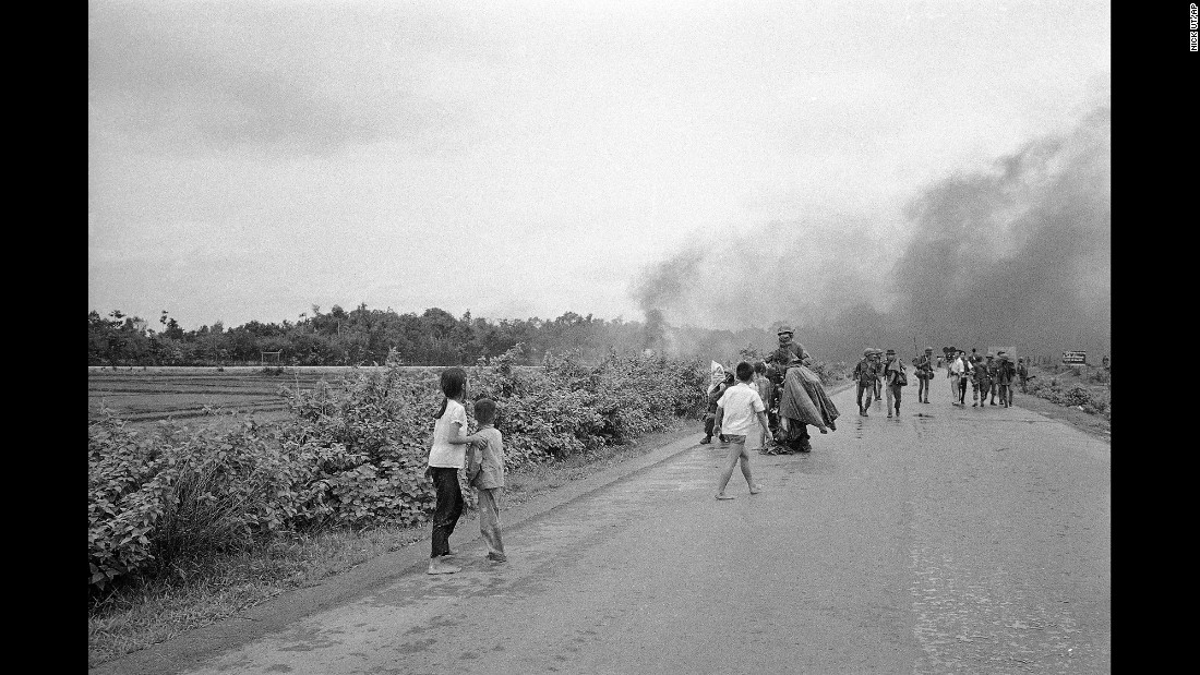 Injured civilians and soldiers flee from the site of the attack.