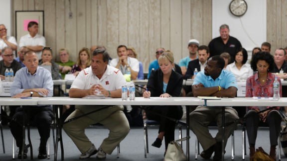 Christie talks to business owners affected by a massive fire that burned a large portion of the Seaside Park boardwalk, which had recently been rebuilt after Superstorm Sandy, on September 14, 2013, in Seaside Heights, New Jersey.