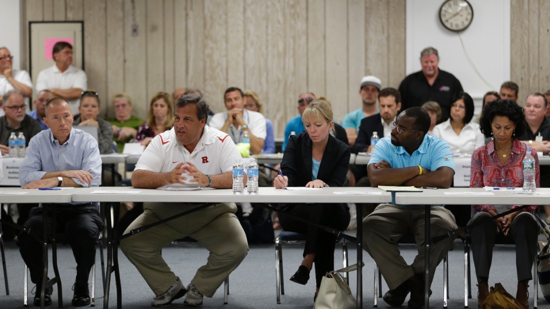 Christie talks to business owners affected by a massive fire that burned a large portion of the Seaside Park boardwalk, which had recently been rebuilt after Superstorm Sandy, on September 14, 2013, in Seaside Heights, New Jersey.