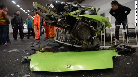 Police investigate the wreckage of the totaled Lamborghini. 