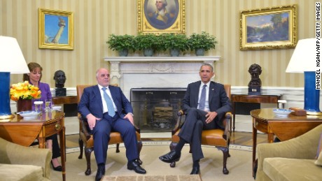 Iraqi Prime Minister Haider al-Abadi (L) and US President Barack Obama await the press corps to set up during a bilateral meeting in the Oval Office on April 14, 2015 in Washington, DC. President Barack Obama met Iraqi Prime Minister Haider al-Abadi in the White House on Tuesday and hailed the progress he said the US-backed Iraqi forces were making against the Islamic State group. 