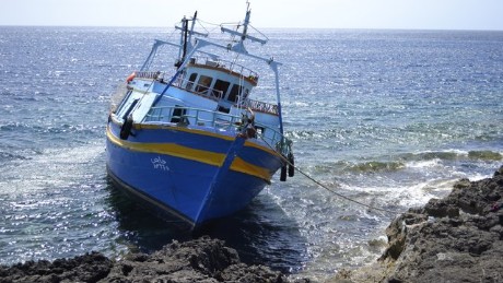 A boat on the rocks off the Italian island of Lampedusa.