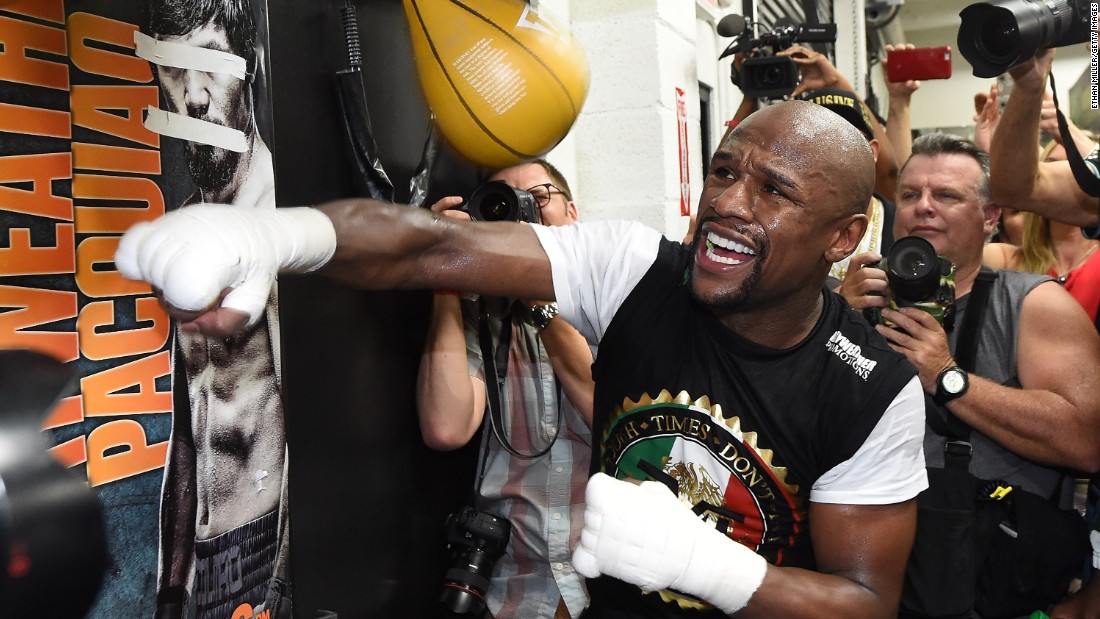 Showing off in front of the reporters, Mayweather pummels a speed bag. Look closely, and you&#39;ll see a poster of Pacquiao with his eyes and mouth taped over.