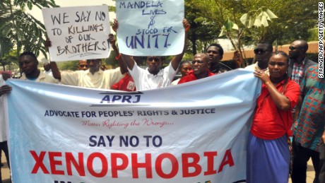 Demonstrators hold banners during a rally called by the NGO Advocate for Peoples&#39; Rights and Justice in front of the office of the South African television DSTV, on April 20, 2015 in Abuja to protest against anti-immigrant violence that erupted last week in South Africa in the economic capital Johannesburg and Durban.