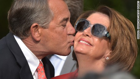 House Speaker John Boehner kisses House Minority Leader Nancy Pelosi during a reception in the Rose Garden of the White House on April 21, 2015.