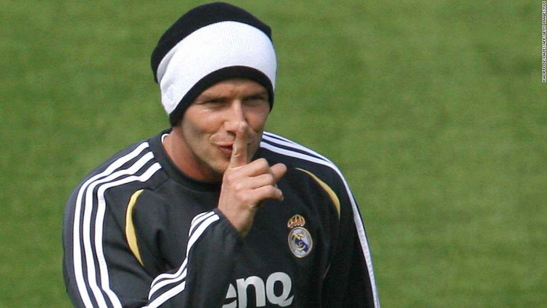 Although Beckham&#39;s life is under constant media scrutiny, sometimes he likes to tease -- here hiding his new hairstyle during a training session in Madrid.
