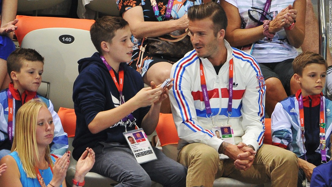 Beckham&#39;s children have grown up in the media glare surrounding him -- here he is pictured with sons (L-R) Cruz, Brooklyn and Romeo Beckham during a diving event at the 2012 London Olympics.  