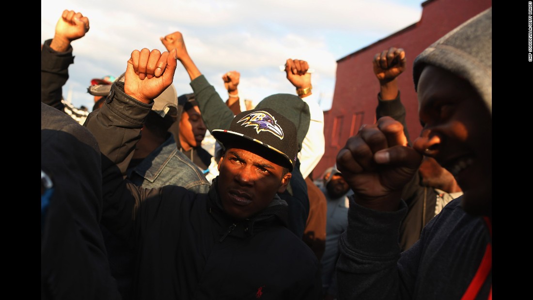 Demonstrators put their fists in the air during a protest outside the Baltimore police&#39;s Western District station on Wednesday, April 22.