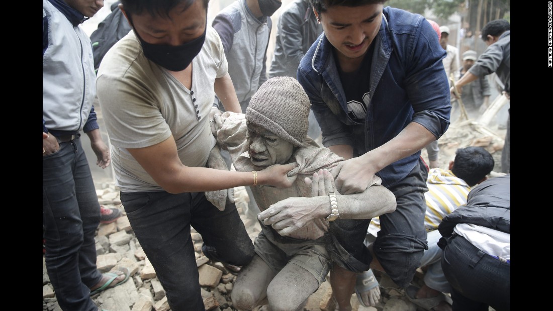 People free a man from the rubble of a destroyed building in Kathmandu.