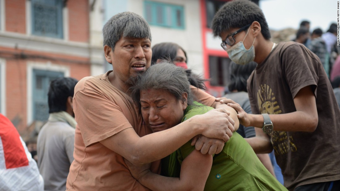 A Nepalese man and woman hold each other in Kathmandu&#39;s Basantapur Durbar Square on April 25.