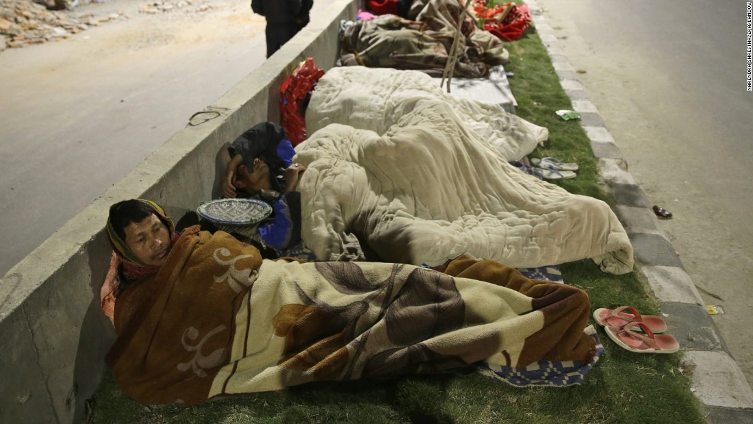 People sleep on a street in Kathmandu, Nepal, on Saturday, April 25. A seemingly endless series of aftershocks continued to roil the area, further traumatizing survivors. 