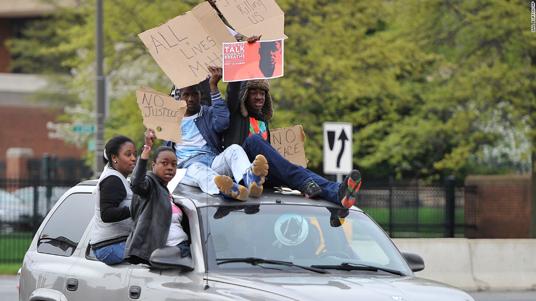 Protesters drive through the Camden Yards area on April 25. 