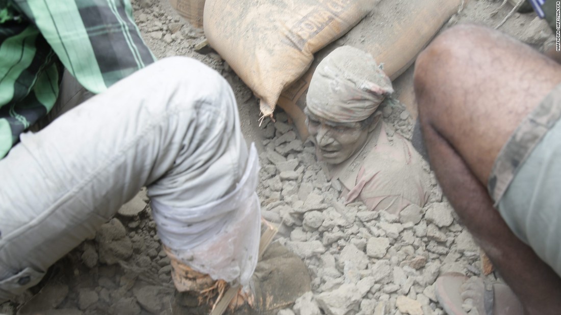 People try to free a man from the rubble in Kathmandu on April 25. Cheers rose from the piles when people were found alive -- but mostly bodies turned up. 