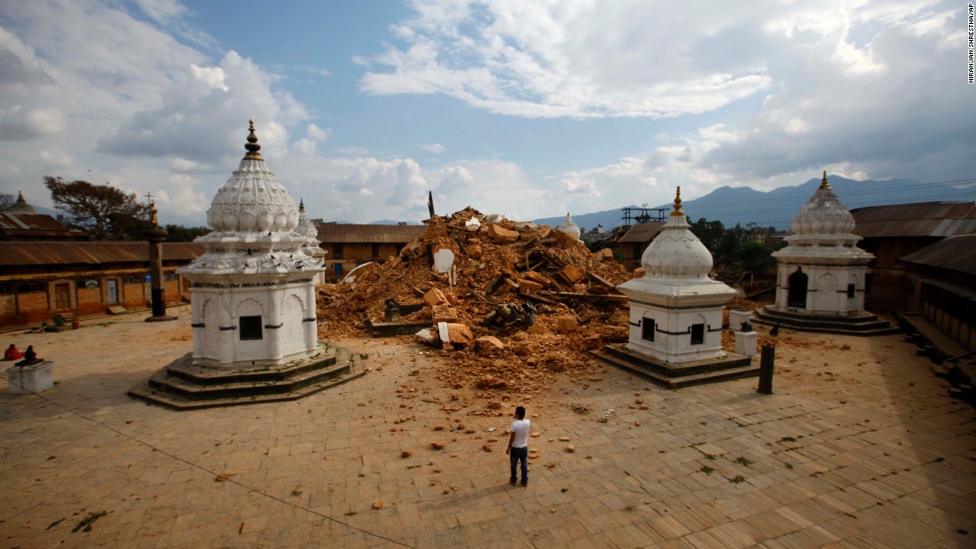 People look at the debris of one of the oldest temples in Kathmandu on April 26.