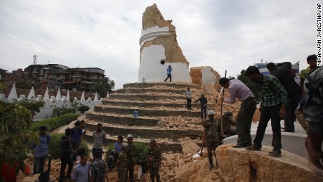 Volunteers work to remove debris at the historic Dharahara tower, a city landmark, after an earthquake in Kathmandu, Nepal, Saturday, April 25, 2015. A strong magnitude-7.9 earthquake shook Nepal&#39;s capital and the densely populated Kathmandu Valley before noon Saturday, causing extensive damage with toppled walls and collapsed buildings, officials said. (AP Photo/ Niranjan Shrestha)