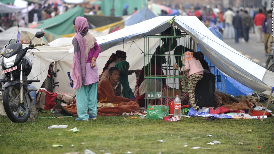 People rest in temporary shelters in Kathmandu on April 27.