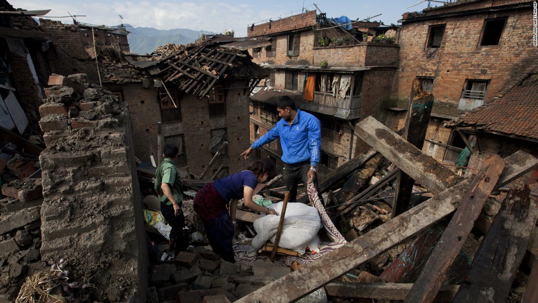 A family collects belongings from their home in Bhaktapur, Nepal, on Monday, April 27. 