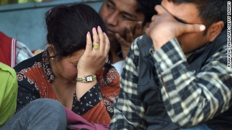 Nepalese residents react as police retrieve the bodies of relatives Chandrawati Mahat, 38, and Prasamsah, 14, during rescue efforts in Balaju in Kathmandu on April 27, 2015. International aid groups and governments intensified efforts to get rescuers and supplies into earthquake-hit Nepal on April 26, 2015, but severed communications and landslides in the Himalayan nation posed formidable challenges to the relief effort. As the death toll surpassed 2,000, the US together with several European and Asian nations sent emergency crews to reinforce those scrambling to find survivors in the devastated capital Kathmandu and in rural areas cut off by blocked roads and patchy phone networks. AFP PHOTO/PRAKASH SINGH        (Photo credit should read PRAKASH SINGH/AFP/Getty Images)