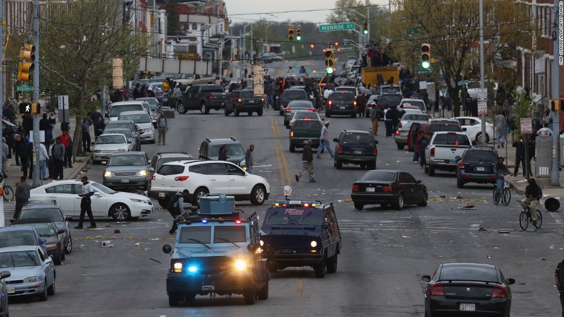 Armored cars drive down Pennsylvania Avenue as looters break into shops on April 27.