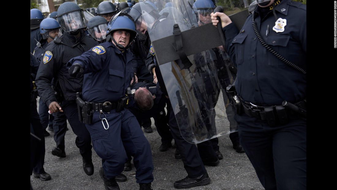 Police carry an injured officer from the streets near Mondawmin Mall in Baltimore on April 27.