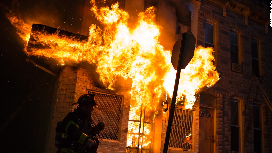 Firefighters respond to a burning building during the riots late April 27.