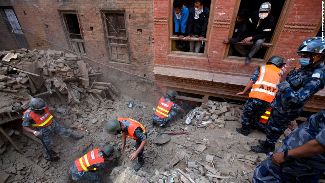 Nepalese military police search through rubble outside Kathmandu on April 28.