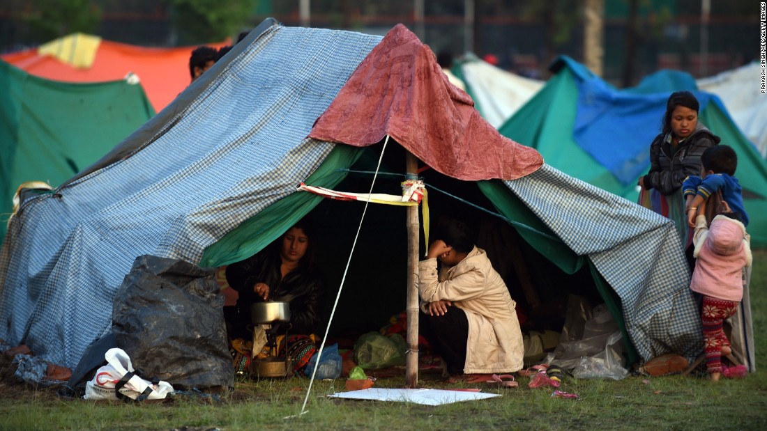 People rest April 28 in a temporary housing camp in Kathmandu. Large encampments of tents have sprung up in open areas, including a wide space belonging to the military in the center of the capital. 