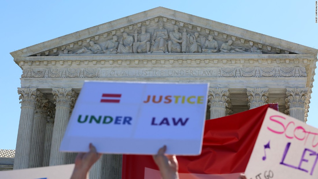 Outside the Supreme Court of the United States, people hold signs calling for &quot;equal justice under law.&quot; 