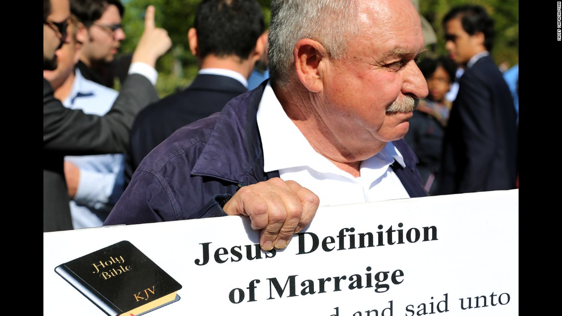 Pastor Larry Hickam holds a sign of what he says is the definition of marriage outside the Supreme Court.