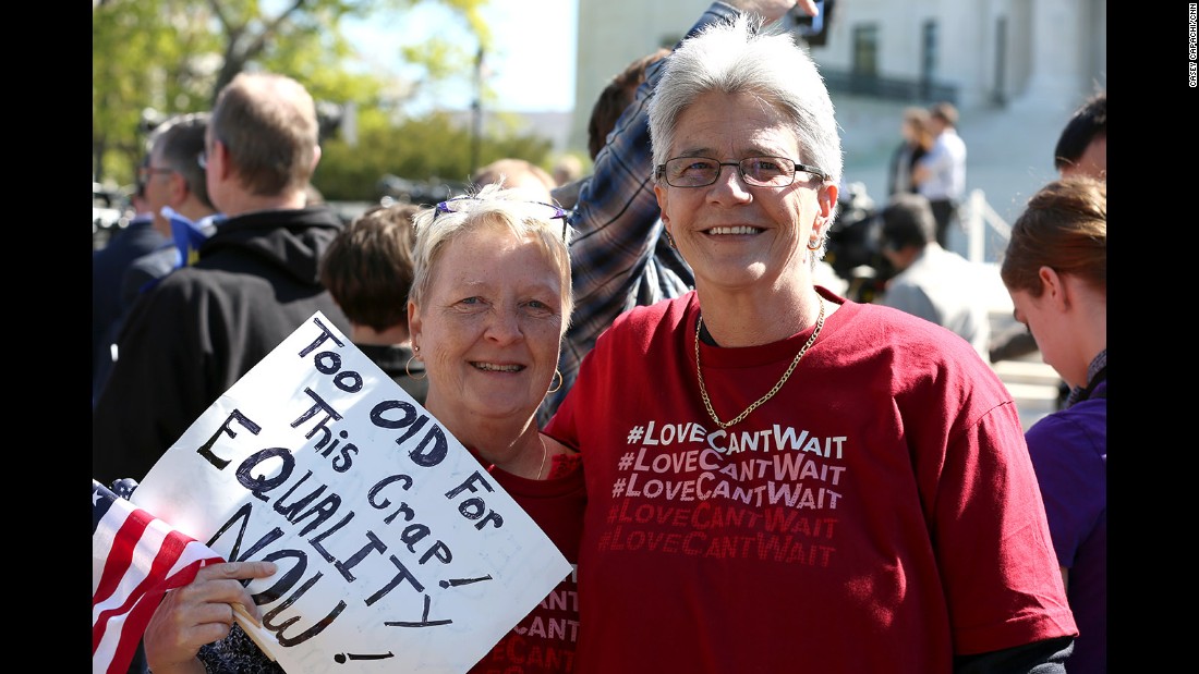 Stephanie Jones and Diana Iwanski of Clermont, Florida, share their sign in support of same-sex marriage outside the Supreme Court.