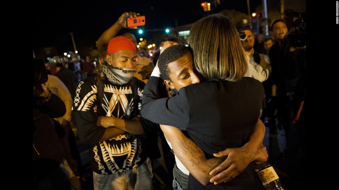 State Sen. Catherine E. Pugh embraces a protester while urging the crowd to disperse ahead of the 10 p.m. curfew.