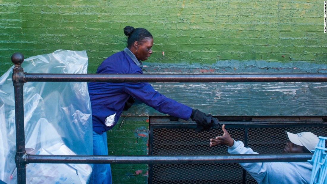 Volunteers help clear trash from a looted business on April 28.