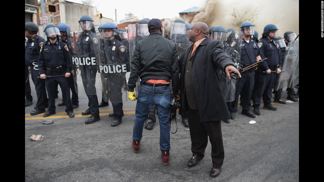 A man attempts to calm a fellow demonstrator as they face police in Baltimore in April 2015. Riots broke out after &lt;a href=&quot;http://www.cnn.com/2015/04/27/us/gallery/freddie-gray-funeral/index.html&quot;&gt;the funeral for Freddie Gray&lt;/a&gt;, who died of a severe spinal cord injury while in police custody. His death sparked &lt;a href=&quot;http://www.cnn.com/2015/04/23/us/gallery/freddie-gray-protest/index.html&quot;&gt;protests in Baltimore&lt;/a&gt; and raised long-simmering tensions between police and residents.