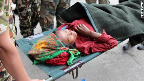 Forshani Tamang, whose children carried her the four hours from her village, Bachunde, to Malamchi for help, is picked up at the Kathmandu air base to be taken to hospital. 