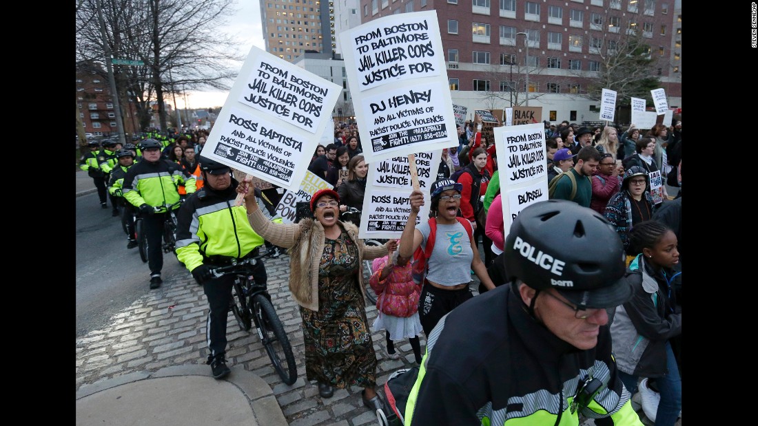 Demonstrators march with a police escort near Boston police headquarters on April 29.